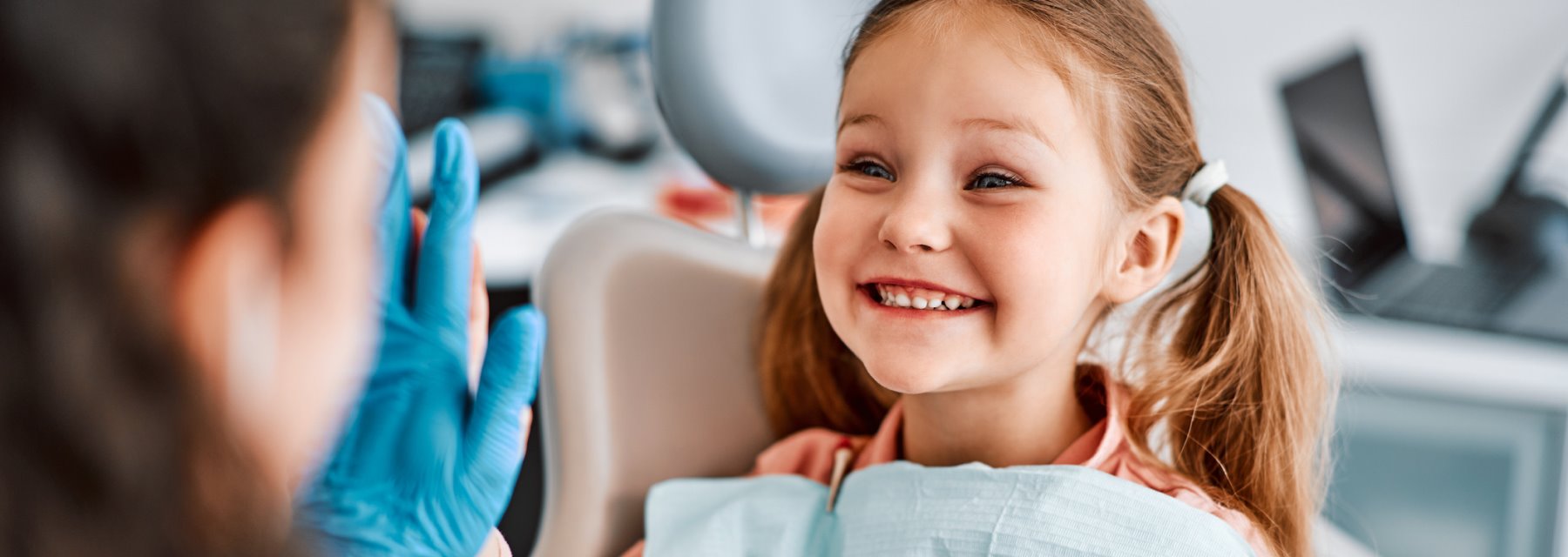 A Cheerful Little Girl Sits In A Dentist Chair, Excited For Her First Dental Appointment At Walton Way Ext., Augusta, Georgia