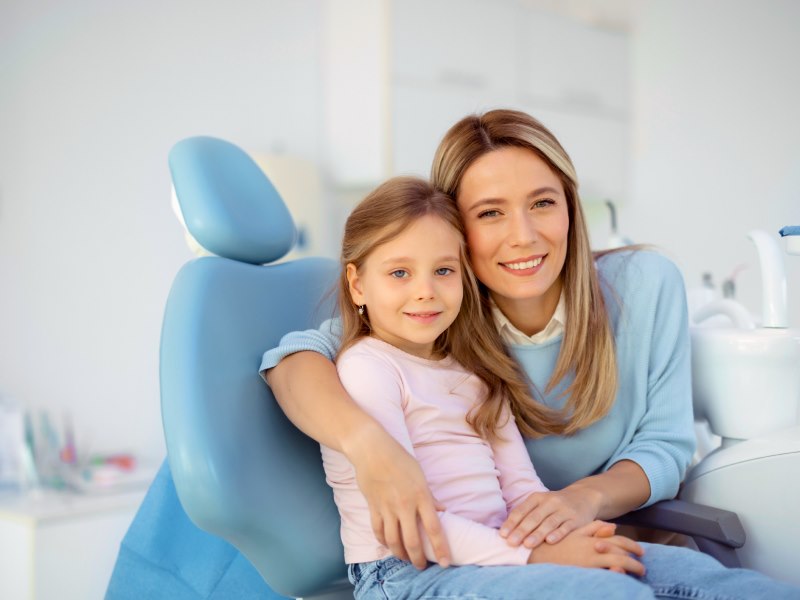 Woman and a little girl seated together during office hours in a dental chair at Walton Way Ext., Augusta, Georgia